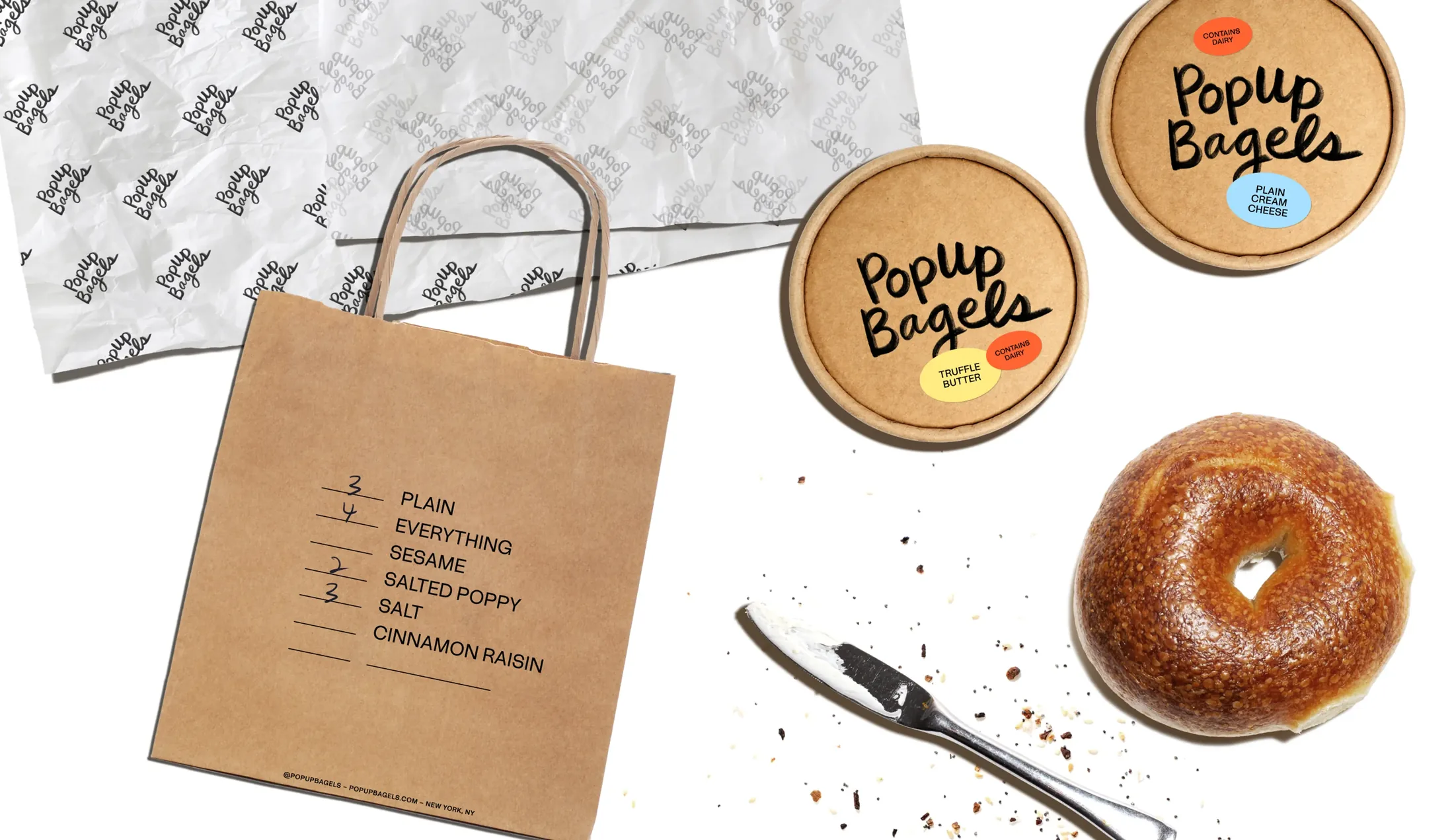 PopUp Bagels packaging and a sesame bagel