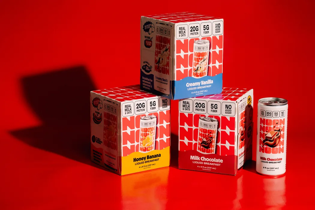 NOON liquid breakfast cartons stacked on a red background