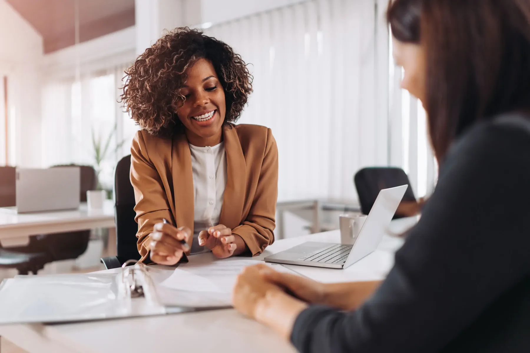 A Farther adviser meeting a client across a desk